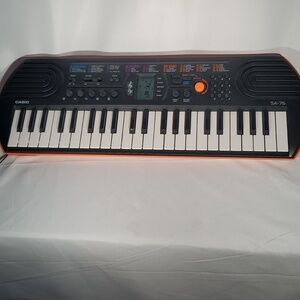 Casio SA-76 Portable Keyboard in Black and Orange